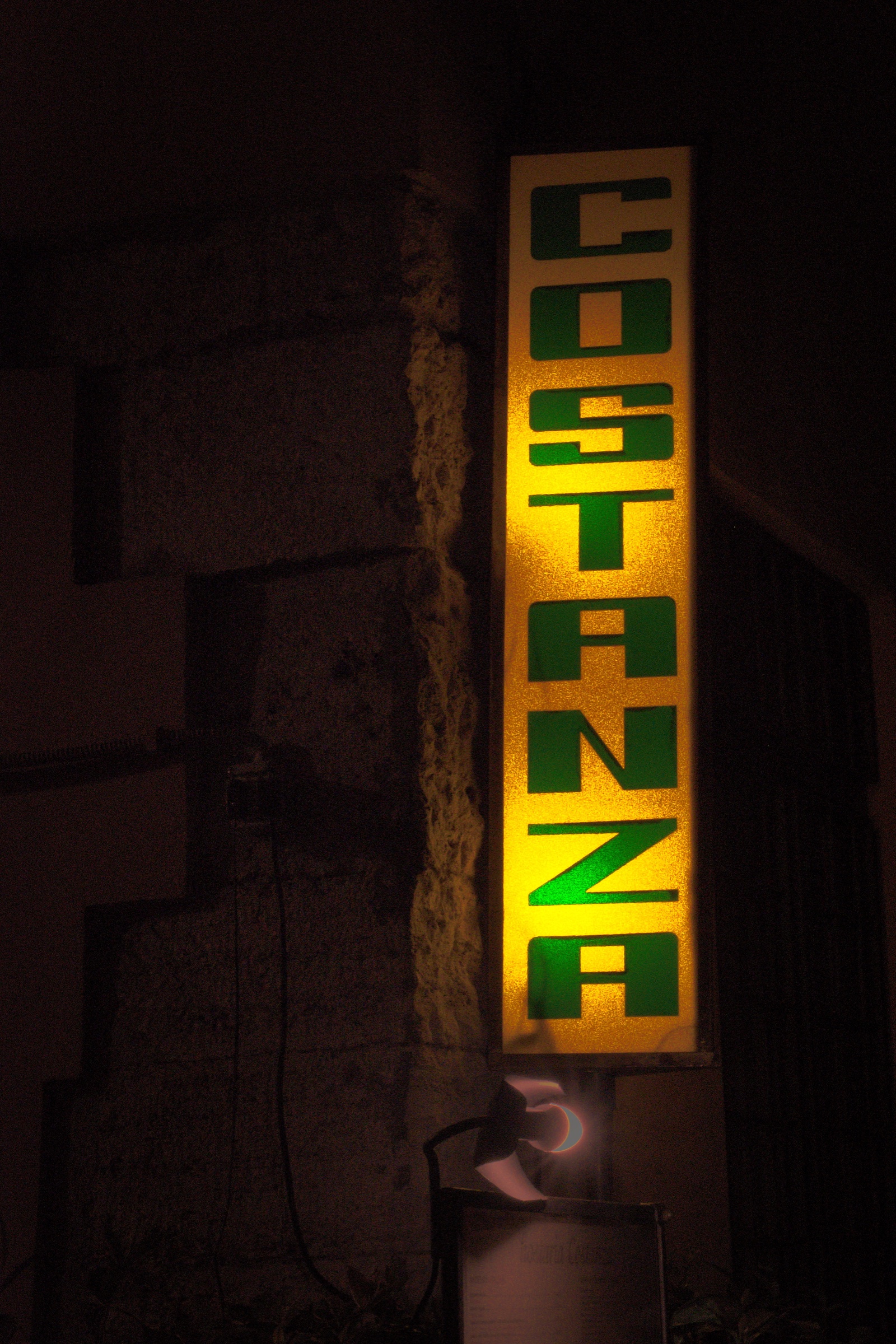 Costanza sign glowing at night